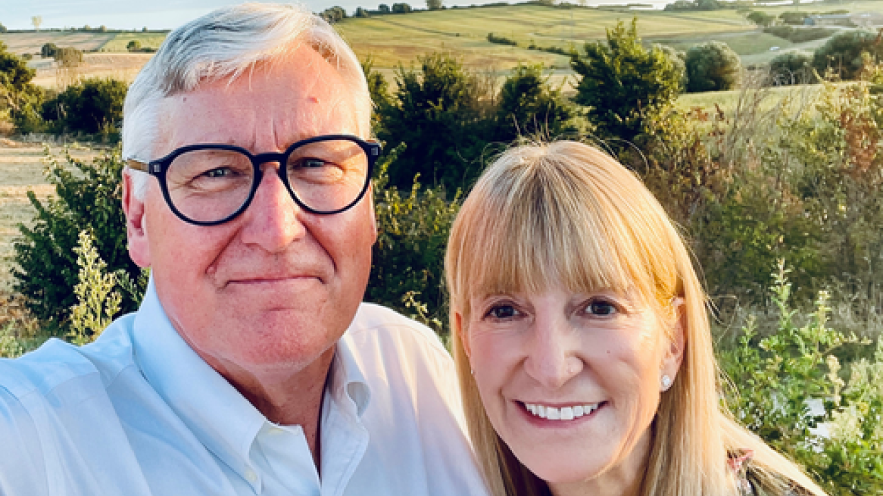 Lange and Puma smile overlooking the Umbria region in Italy.
