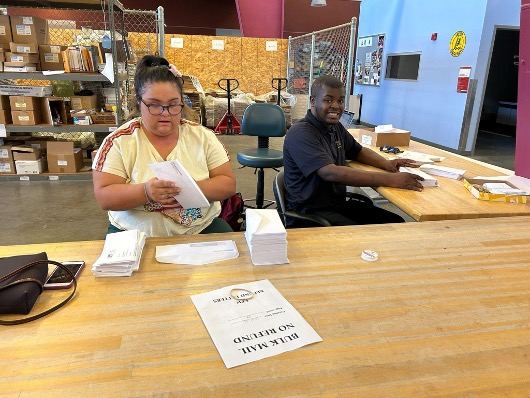 Jaylen and Christina, seniors, working at the Mail Distribution Center.