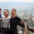 Image of three students looking into the camera and smiling